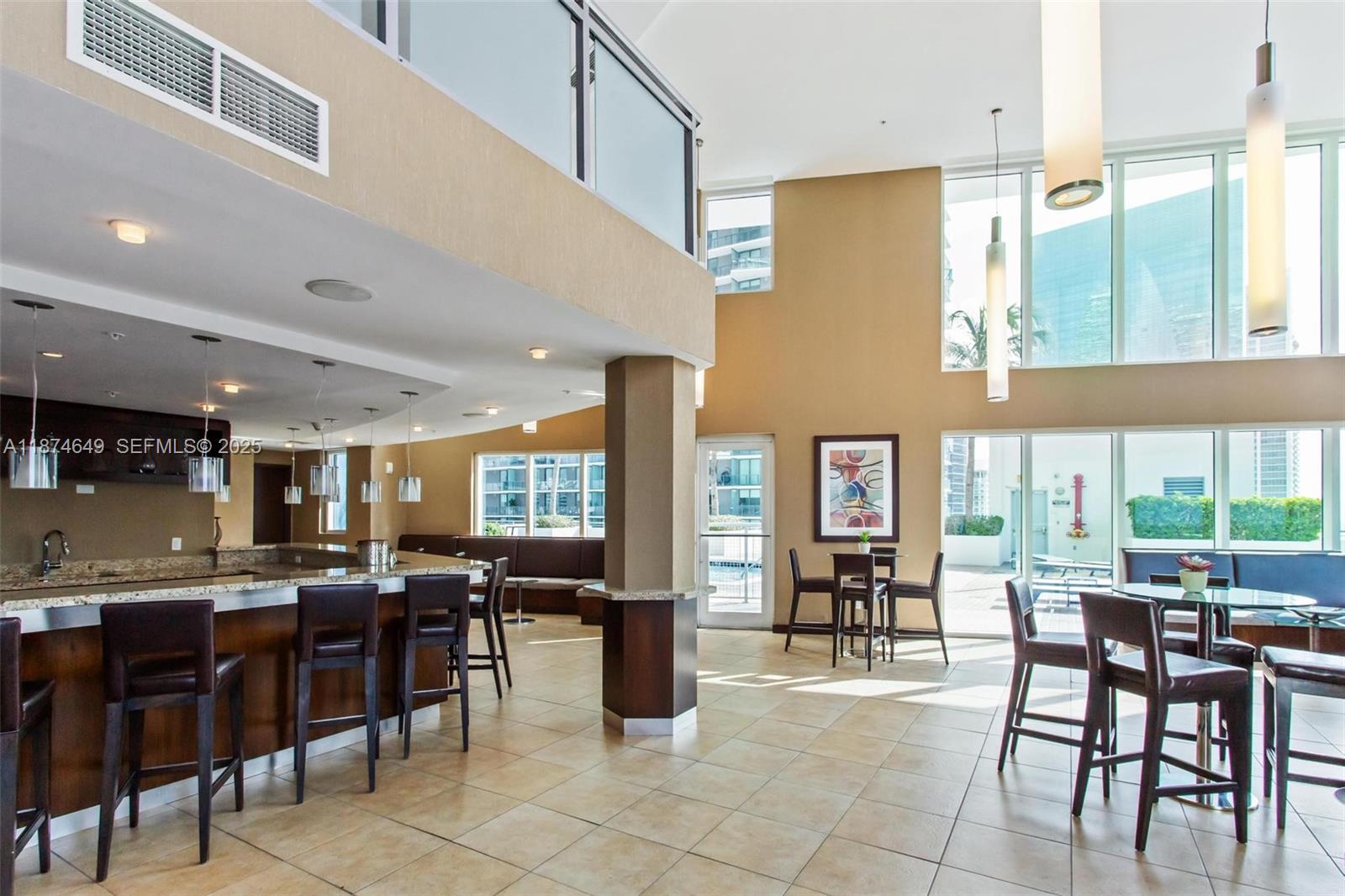 60 Southwest 13th Street, Unit 4413 Miami, FL 33130 - Photo 40 of 41 a kitchen with lots of counter top space and dining table