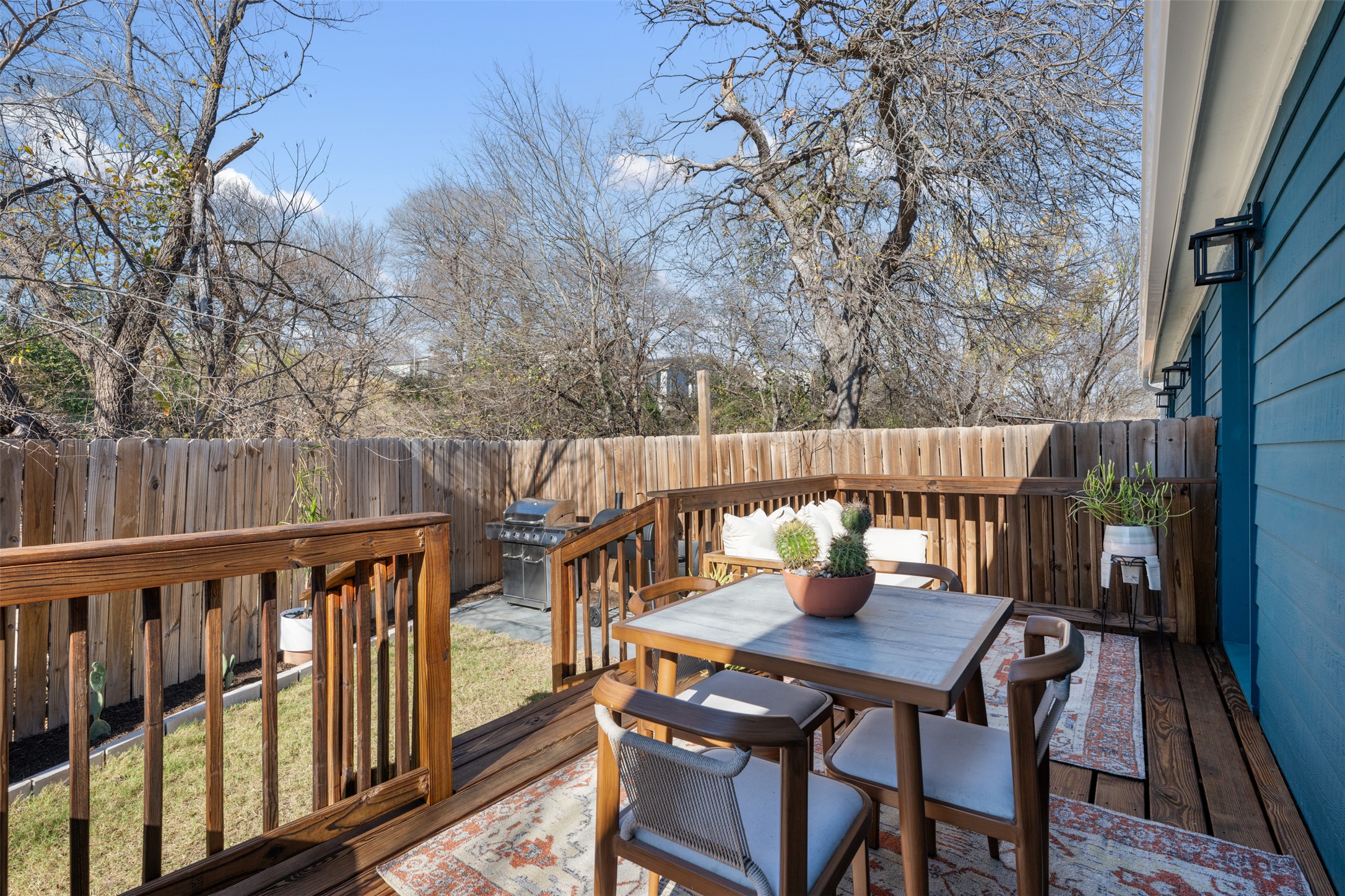 1616 Webberville Road, Unit A Austin, TX 78721 - Photo 26 of 35 Wooden terrace with outdoor dining area, a fenced backyard, and grilling area