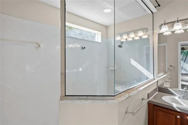 a view of a bathroom with a shower and a sink