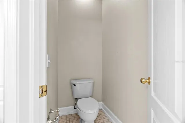 a white toilet sitting next to a white wall