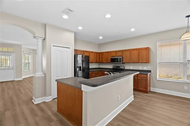 a kitchen with stainless steel appliances granite countertop a sink a stove and a refrigerator