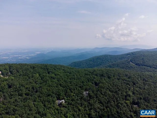 a view of a field of grass and mountain