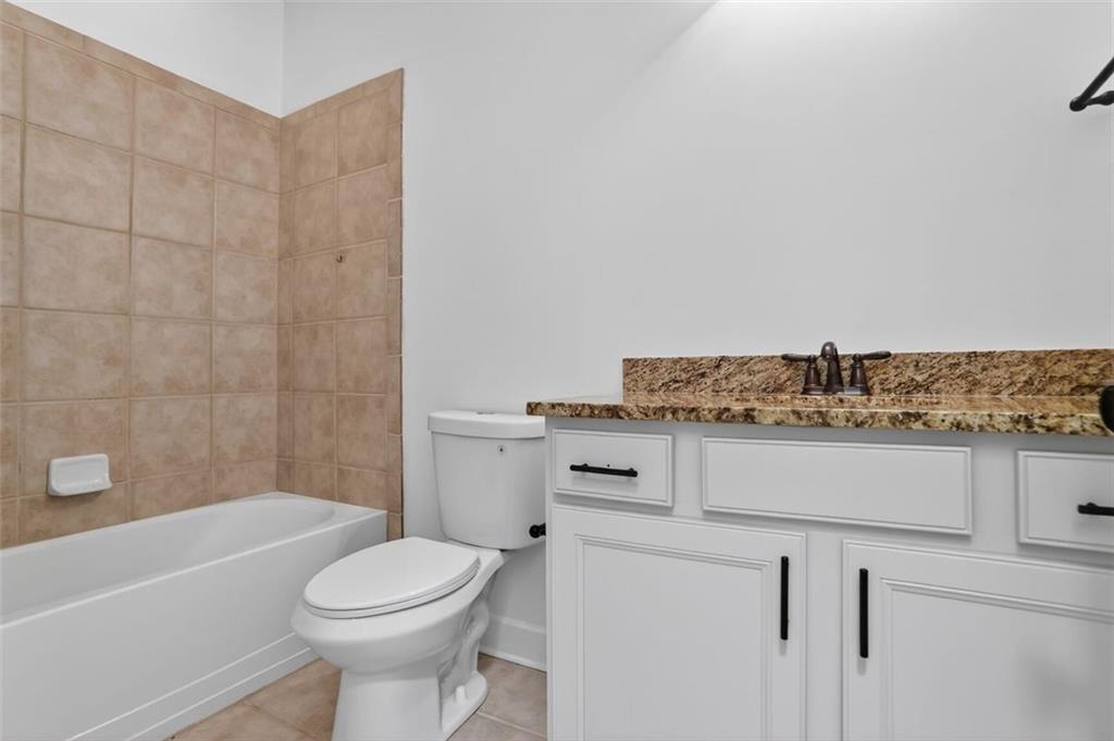 3267 Ferncliff Lane Atlanta, GA 30324 - Photo 25 of 25 a bathroom with a granite countertop toilet sink and mirror