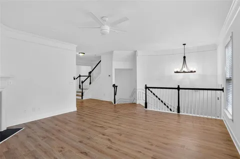 a view of a room with wooden floor and staircase