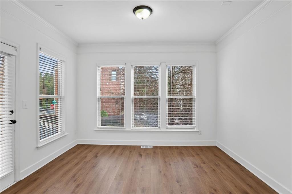 3267 Ferncliff Lane Atlanta, GA 30324 - Photo 7 of 25 an empty room with wooden floor and windows