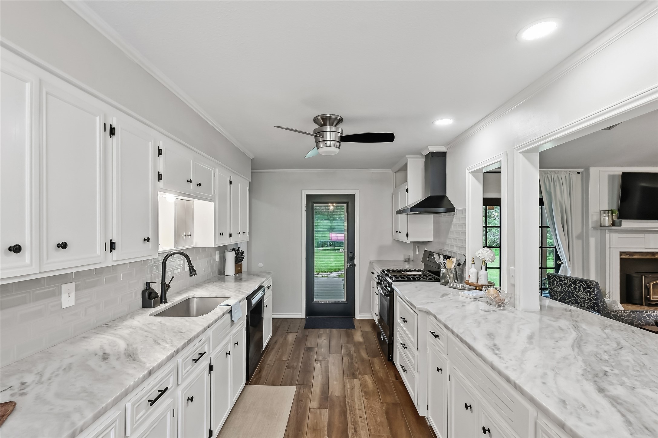 906 Standley Road Madisonville, TX 77864 - Photo 16 of 40 a large kitchen with granite countertop a sink and cabinets