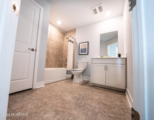 a view of a workspace with furniture and wooden floor