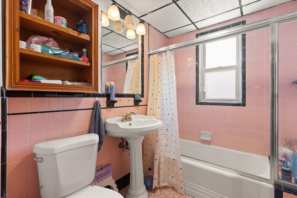 25-27 Upland Road Somerville, MA 02144 - Photo 14 of 38 a bathroom with a sink a toilet and shower