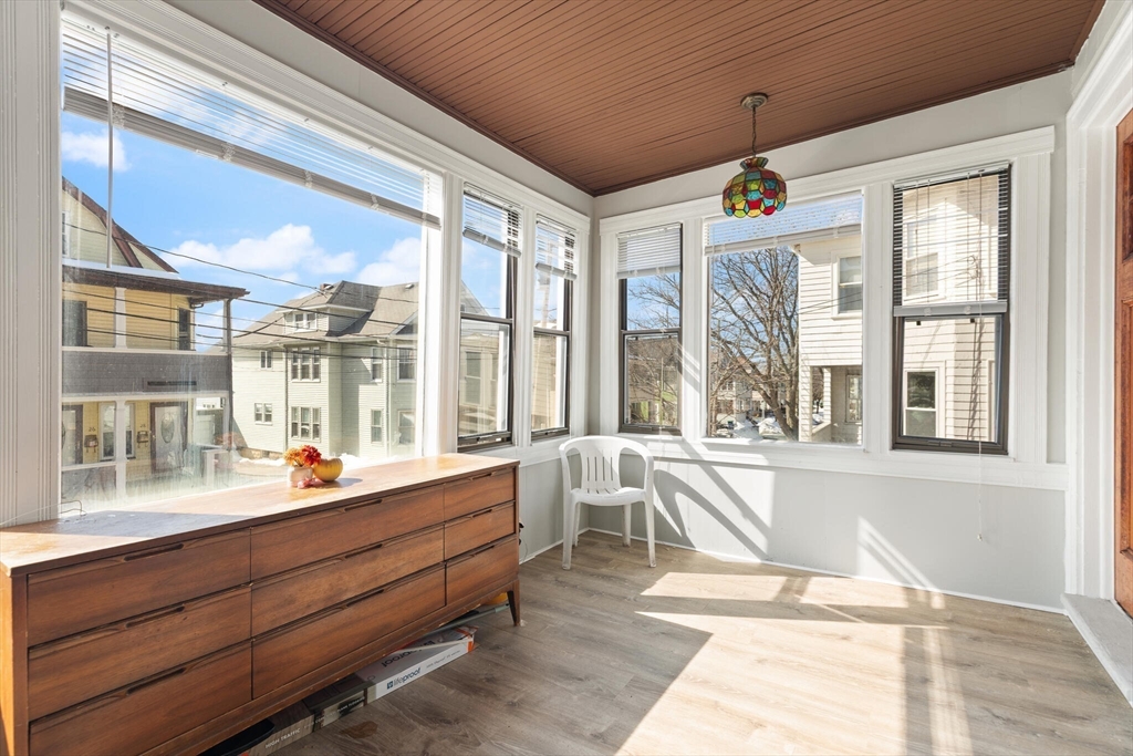 25-27 Upland Road Somerville, MA 02144 - Photo 2 of 38 a room with large windows and furniture