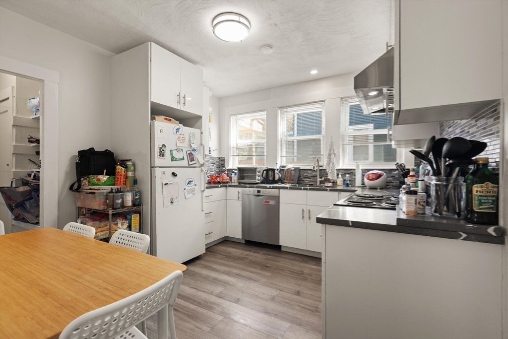 25-27 Upland Road Somerville, MA 02144 - Photo 21 of 38 a kitchen that has a lot of cabinets in it and appliances