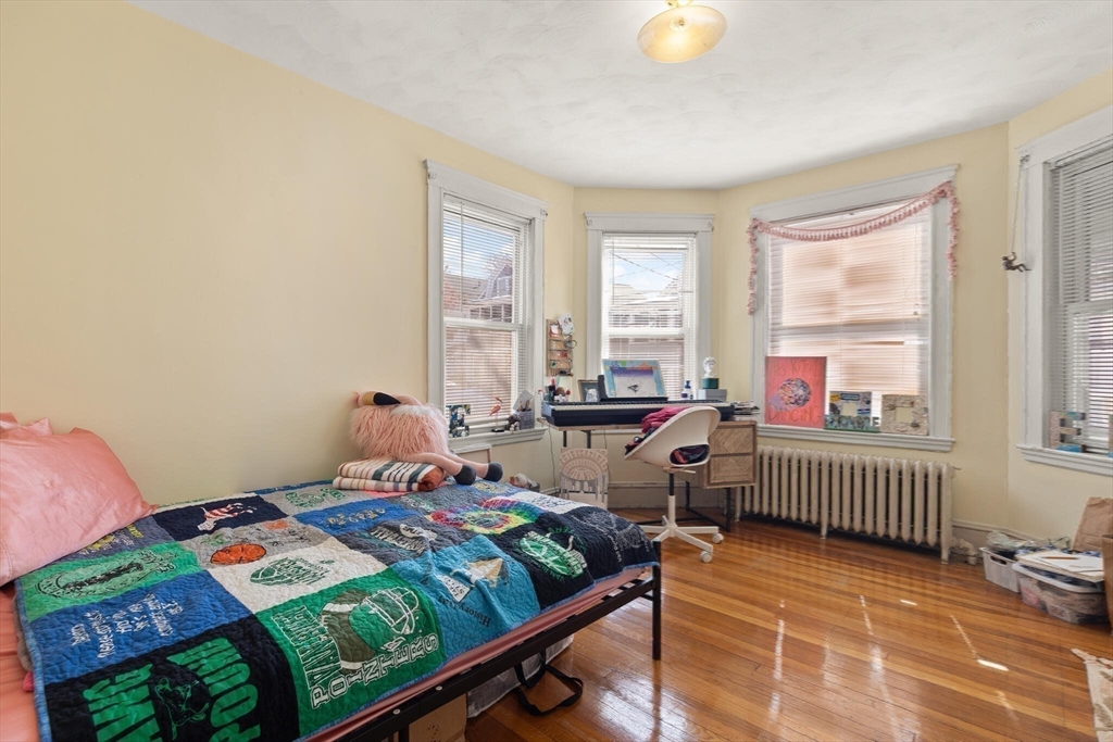 25-27 Upland Road Somerville, MA 02144 - Photo 23 of 38 a bedroom with a bed and a window