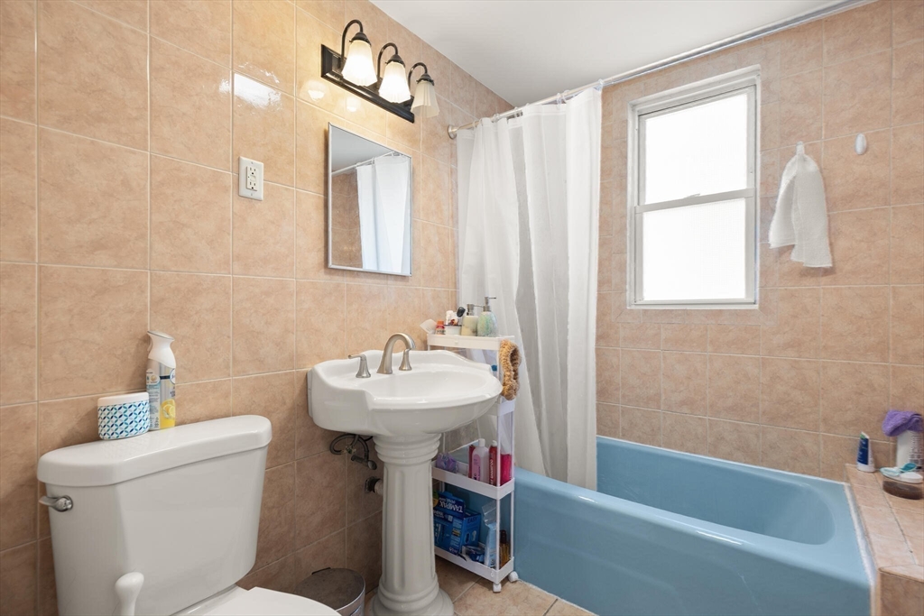 25-27 Upland Road Somerville, MA 02144 - Photo 24 of 38 a bathroom with a sink a toilet and bathtub