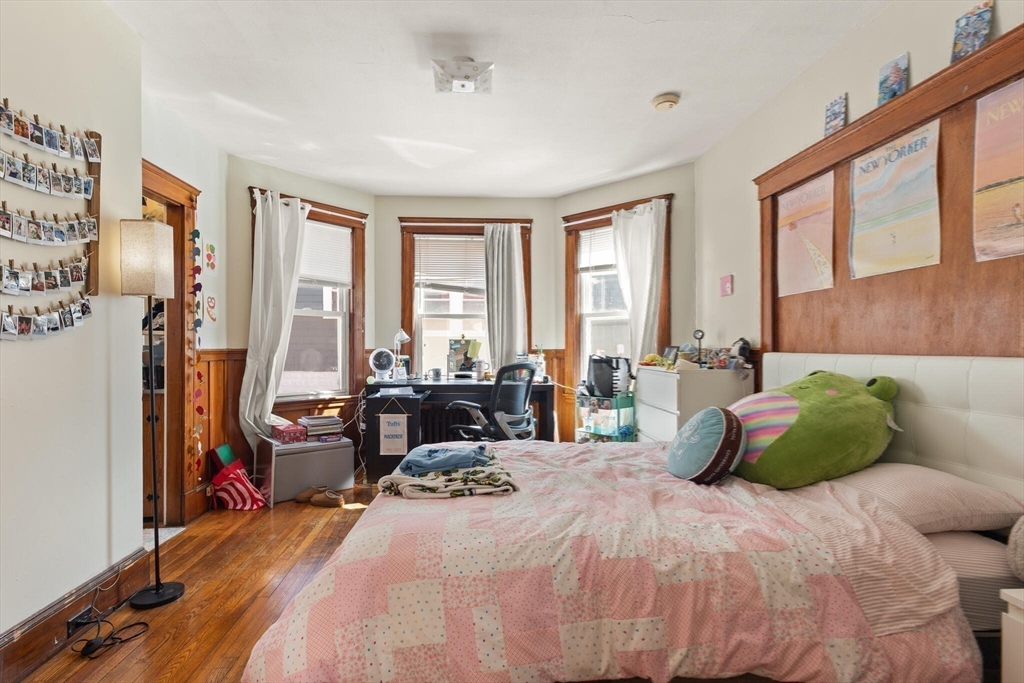 25-27 Upland Road Somerville, MA 02144 - Photo 25 of 38 a bedroom with a bed and large windows