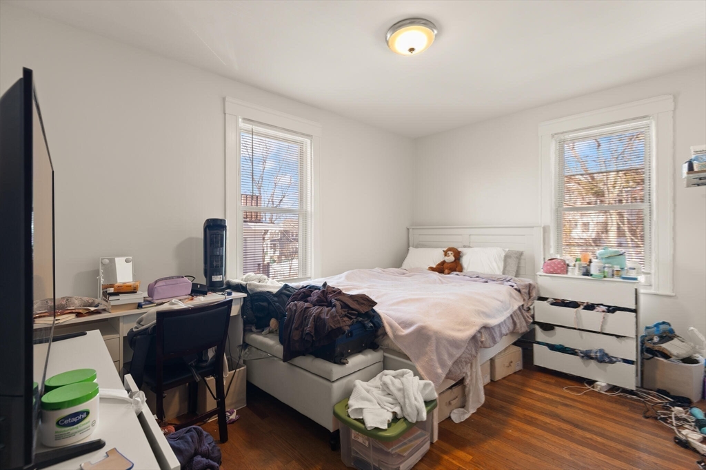 25-27 Upland Road Somerville, MA 02144 - Photo 27 of 38 a bedroom with a bed and a window