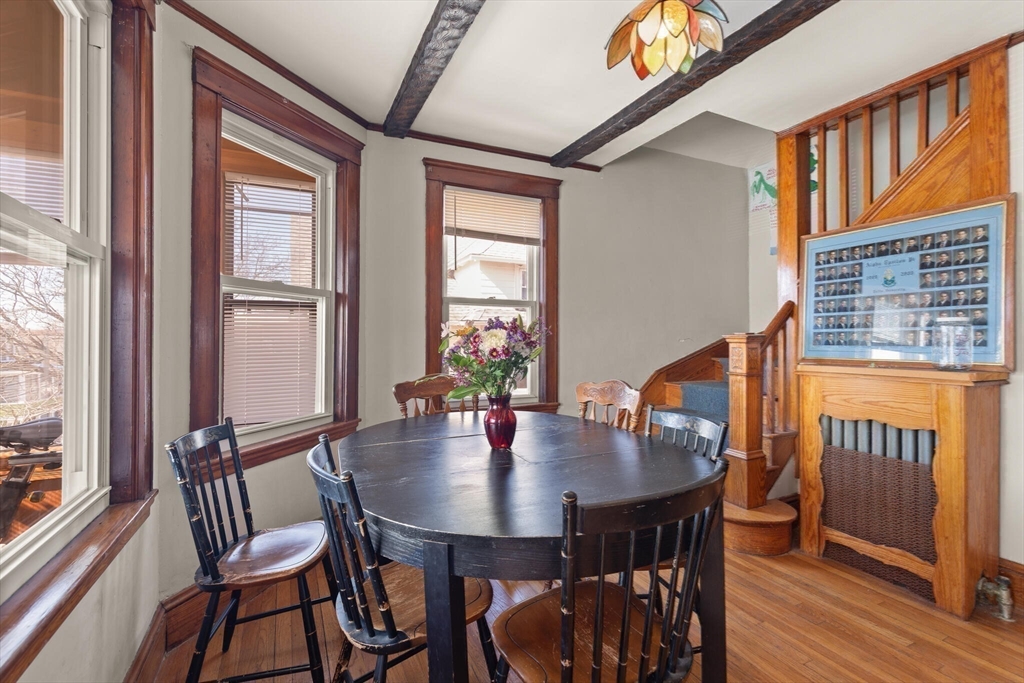 25-27 Upland Road Somerville, MA 02144 - Photo 3 of 38 a view of a dining room with furniture window and wooden floor