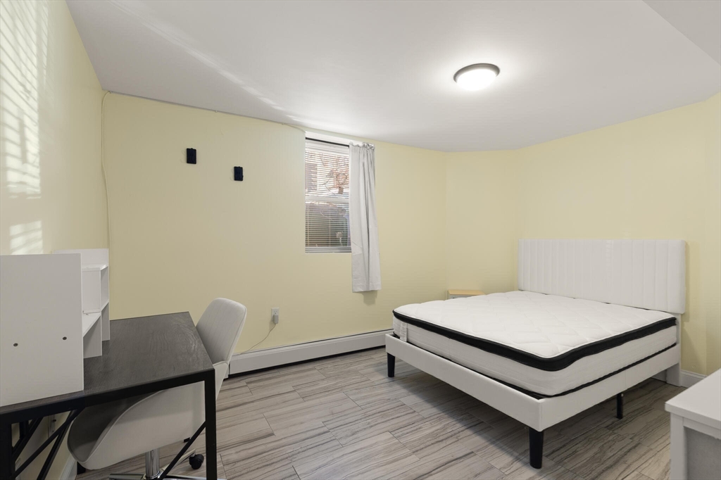 25-27 Upland Road Somerville, MA 02144 - Photo 34 of 38 a room with a bed and a desk