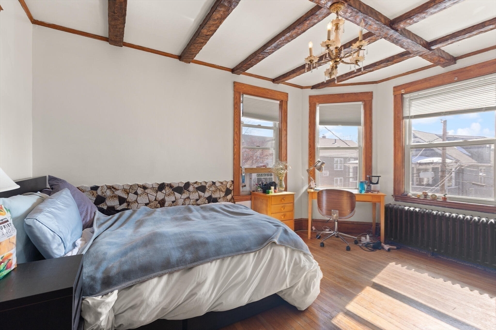 25-27 Upland Road Somerville, MA 02144 - Photo 8 of 38 a bedroom with a bed and a large window with the outer view