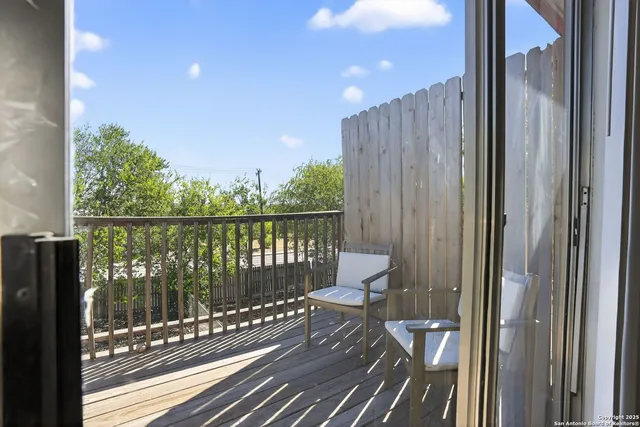 a view of a balcony with wooden floor