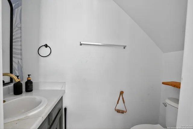 a bathroom with a sink and mirror