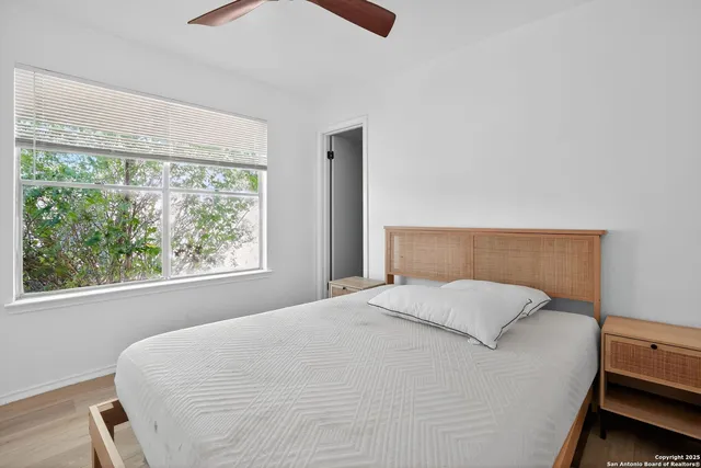 a large bed sitting in a bedroom next to a window