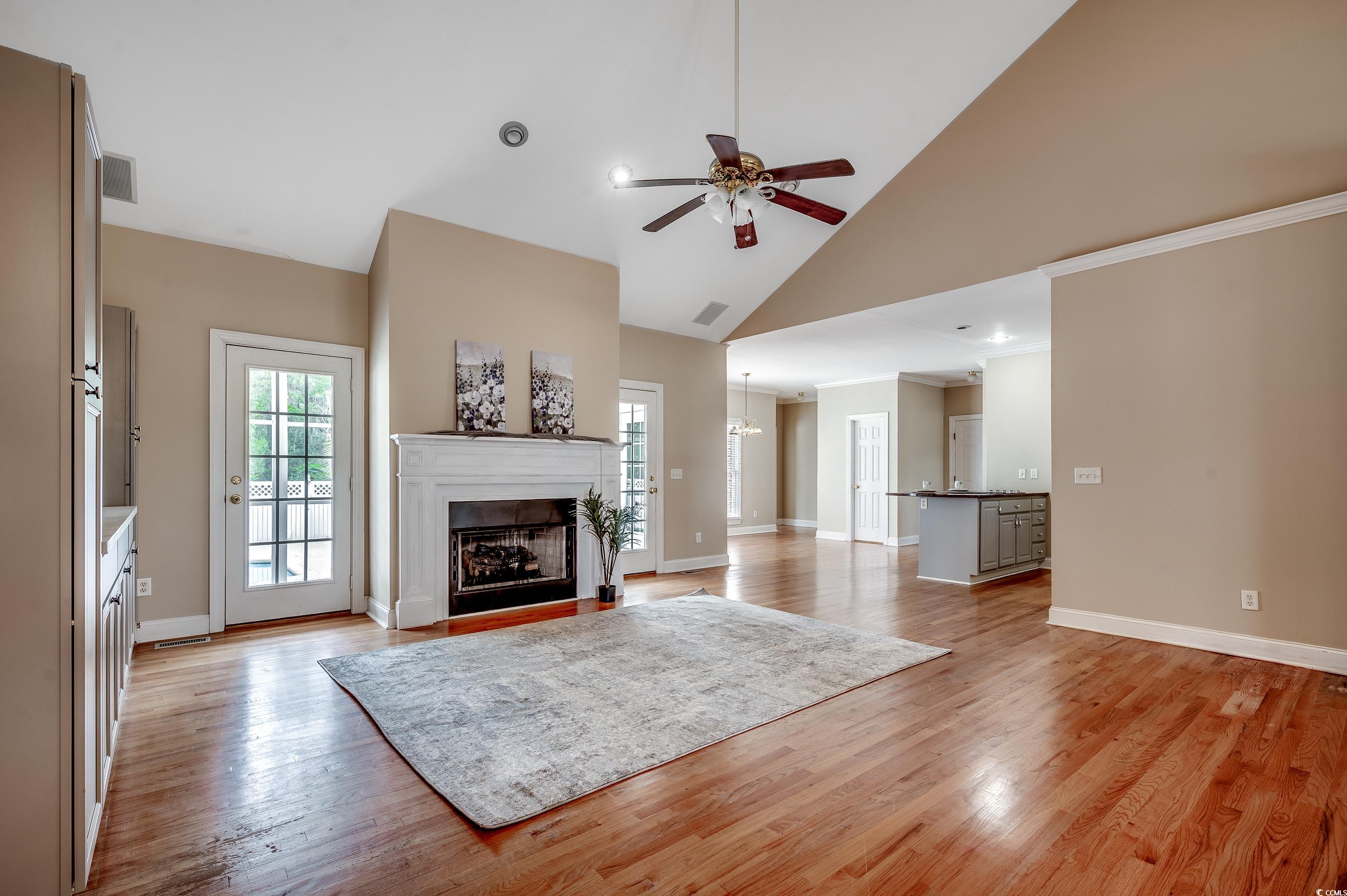 391 William Nobles Road Aynor, SC 29511 - Photo 3 of 38 Living room with a ceiling fan, a fireplace, high vaulted ceiling, light wood-style flooring, and a chandelier