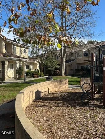 a backyard of a house with table and chairs