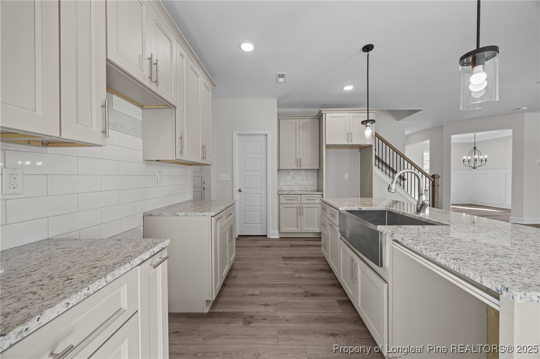 785 Quewhiffle (lot 3) Road Aberdeen, NC 28315 - Photo 12 of 50 a kitchen with granite countertop a sink and a stove