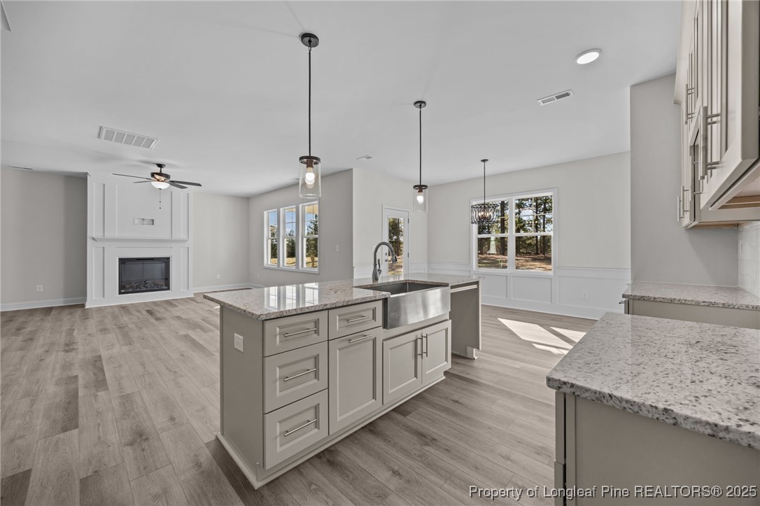 785 Quewhiffle (lot 3) Road Aberdeen, NC 28315 - Photo 15 of 50 a kitchen with stainless steel appliances granite countertop a sink a oven a stove and a wooden floors