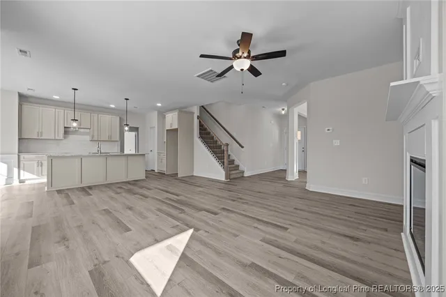 a view of an empty room with a ceiling fan