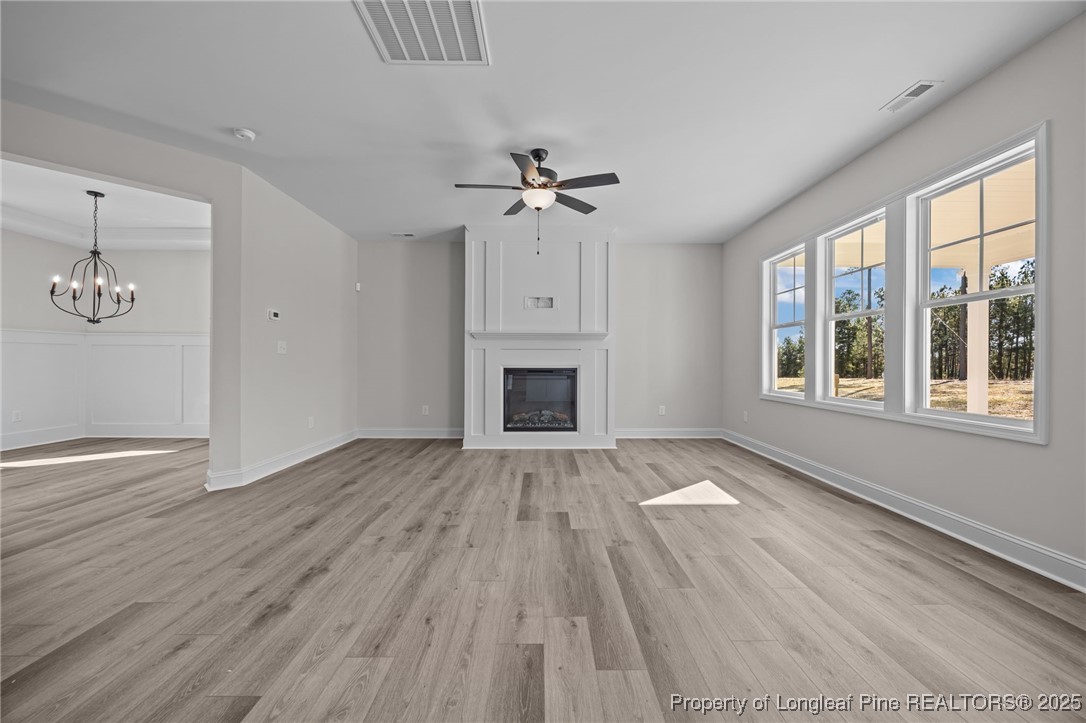 785 Quewhiffle (lot 3) Road Aberdeen, NC 28315 - Photo 20 of 50 a view of an empty room with a window and wooden floor