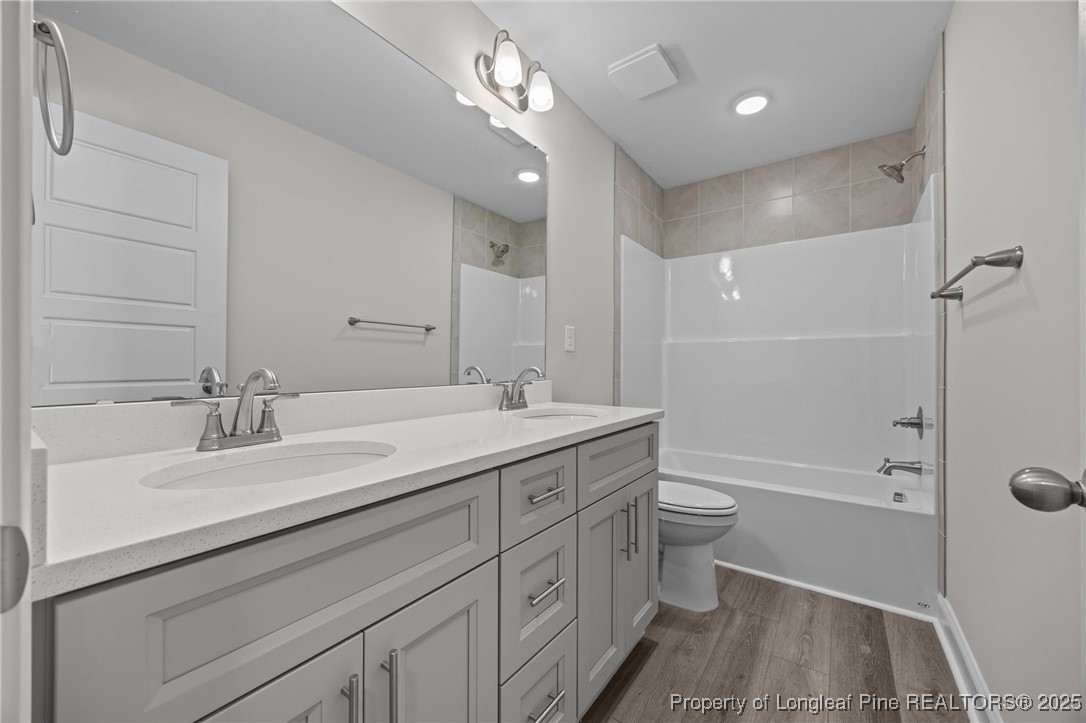 785 Quewhiffle (lot 3) Road Aberdeen, NC 28315 - Photo 23 of 50 a bathroom with a double vanity sink toilet mirror and bathtub
