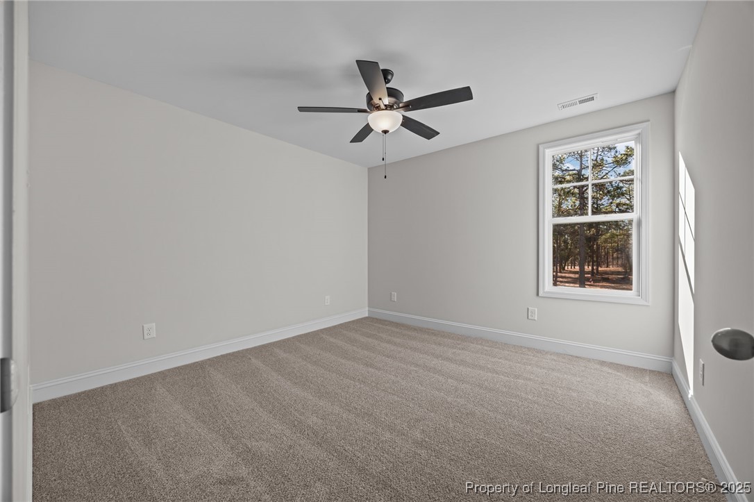 785 Quewhiffle (lot 3) Road Aberdeen, NC 28315 - Photo 26 of 50 an empty room with windows and fan