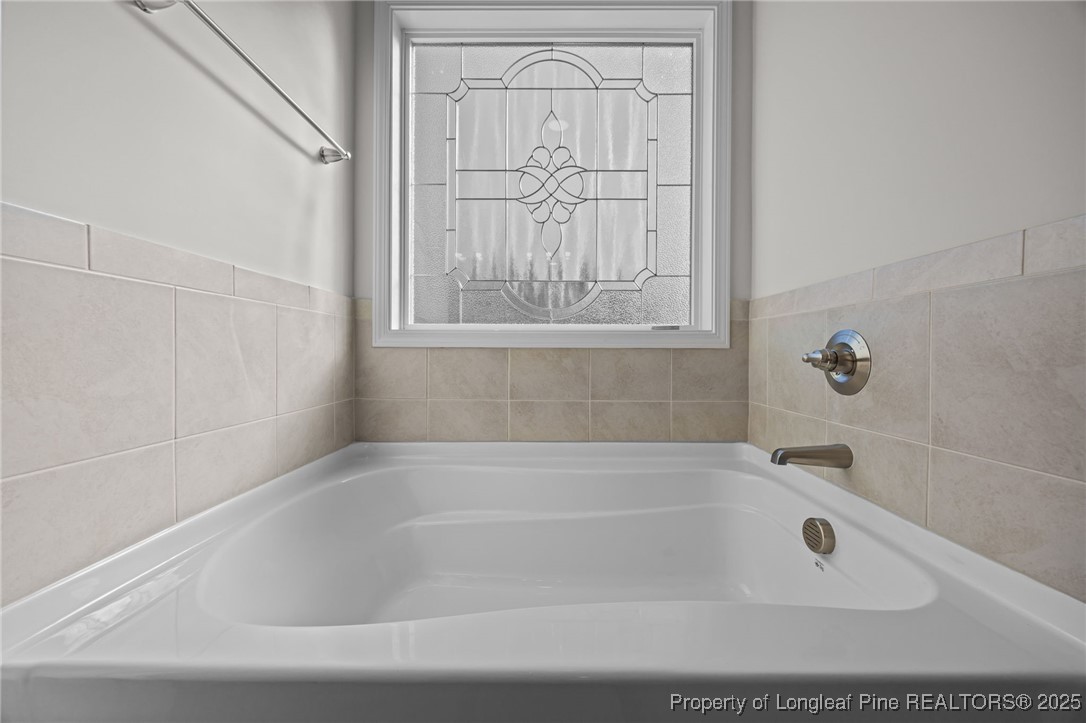 785 Quewhiffle (lot 3) Road Aberdeen, NC 28315 - Photo 34 of 50 a white bath tub sitting next to a window