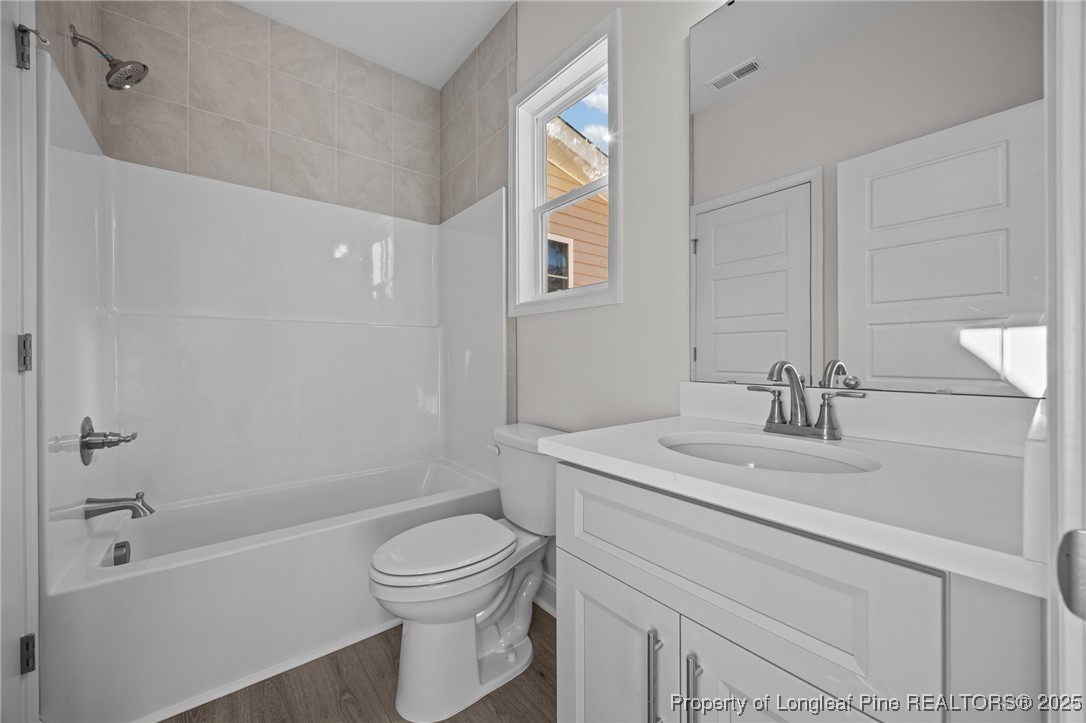785 Quewhiffle (lot 3) Road Aberdeen, NC 28315 - Photo 36 of 50 a bathroom with a granite countertop sink toilet a mirror and shower