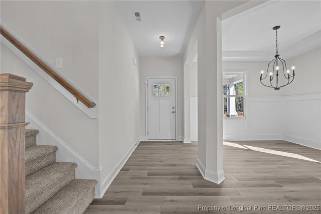 a kitchen with stainless steel appliances granite countertop a sink a oven a stove and a wooden floors