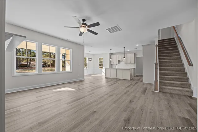 a view of a kitchen with wooden floor and a kitchen space