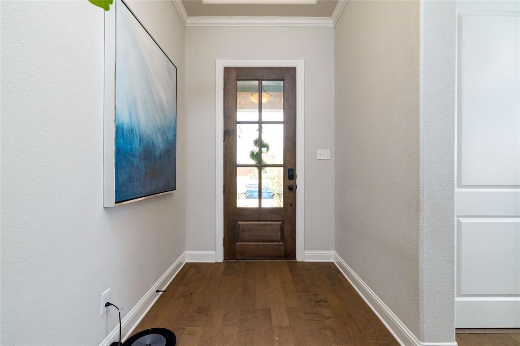 4045 Grove Valley Road Midlothian, TX 76065 - Photo 5 of 34 Doorway to outside with wood finished floors and ornamental molding