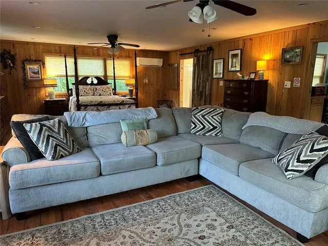 a living room with a bed furniture and a window