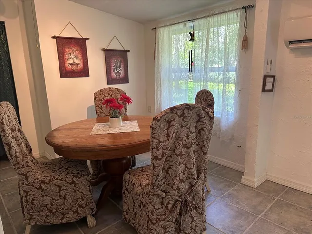 a view of a hallway with wooden floor and chandelier