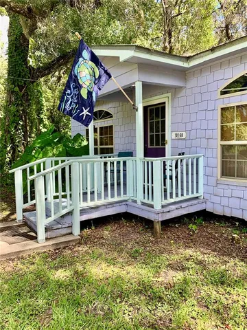 a backyard of a house with table and chairs