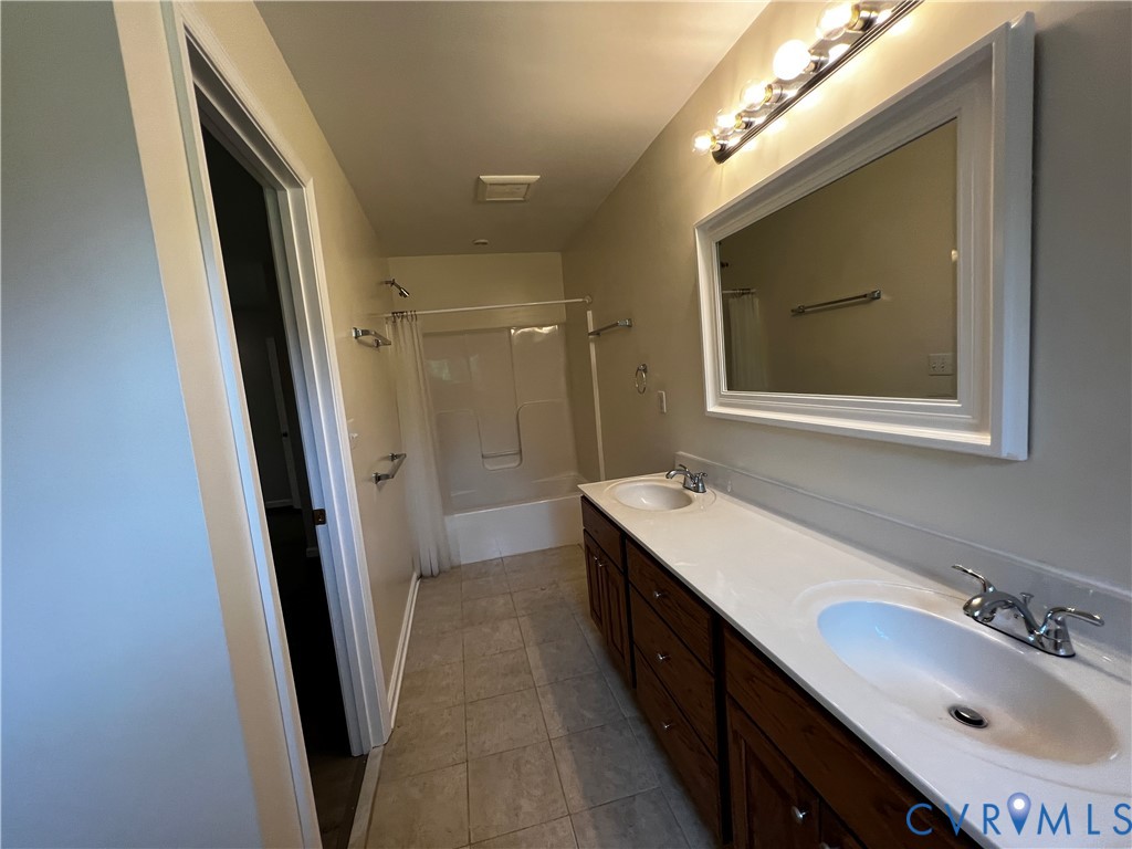 594 Landing Road Farmville, VA 23901 - Photo 11 of 21 a bathroom with a sink a mirror and a shower