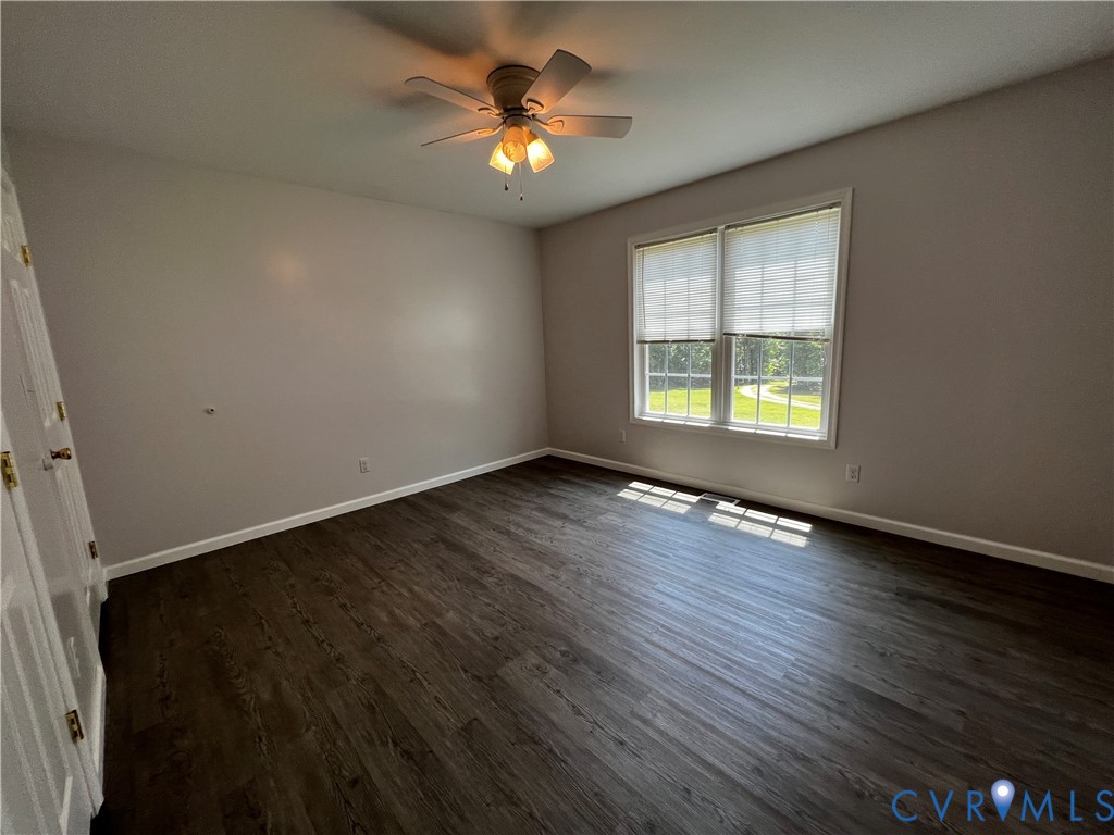 594 Landing Road Farmville, VA 23901 - Photo 17 of 21 an empty room with wooden floor and windows