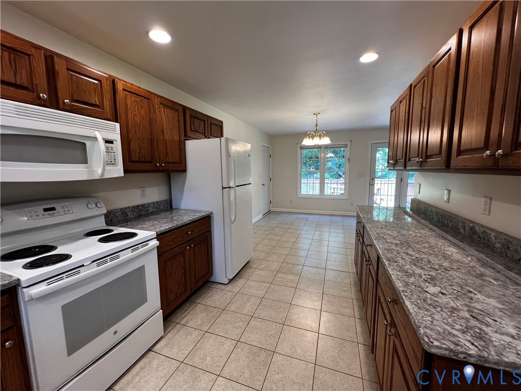 594 Landing Road Farmville, VA 23901 - Photo 7 of 21 a kitchen with stainless steel appliances granite countertop a stove a sink and a microwave