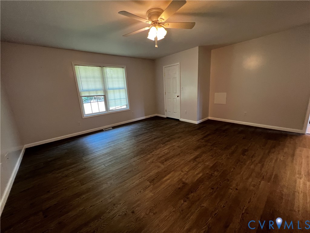 594 Landing Road Farmville, VA 23901 - Photo 9 of 21 a view of an empty room with wooden floor and a window