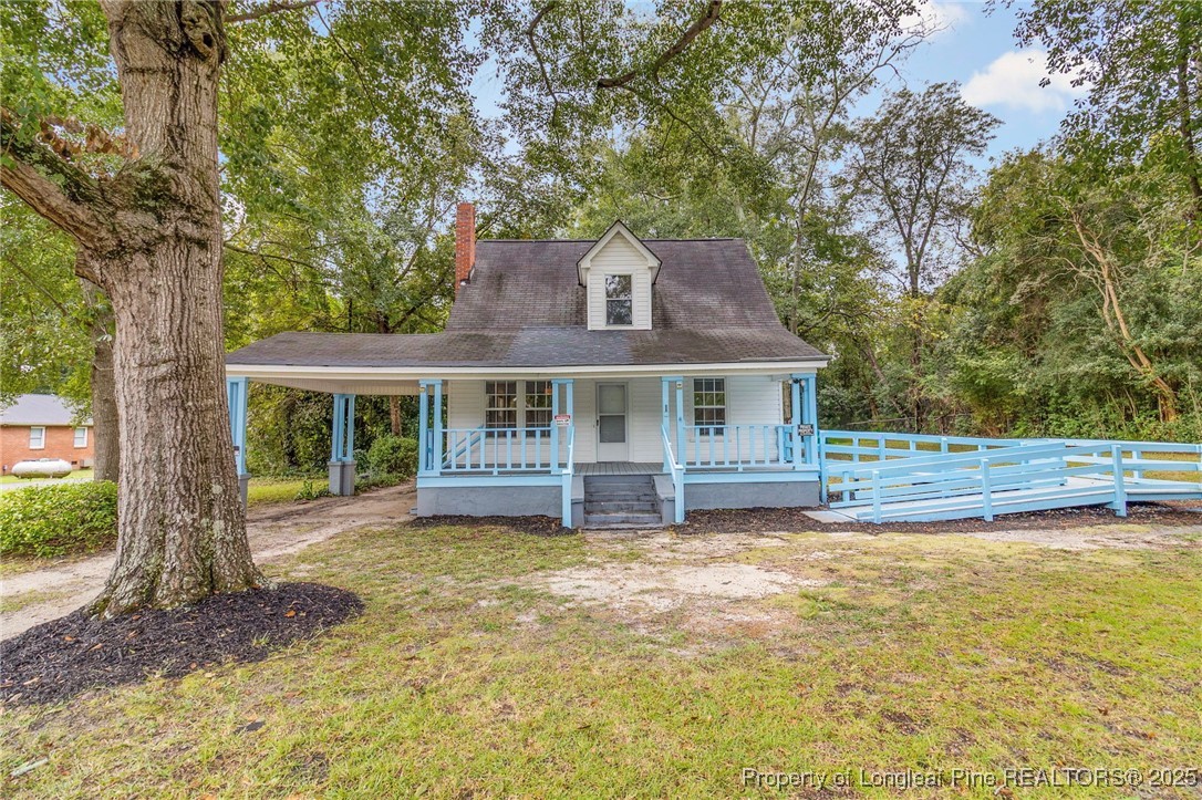 a front view of a house with a yard table and chairs