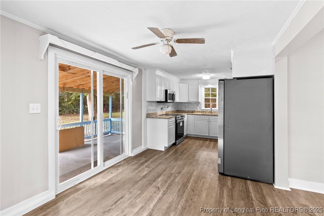 402 Morro Street Fairmont, NC 28340 - Photo 11 of 36 a kitchen with stainless steel appliances granite countertop a refrigerator a sink and a stove