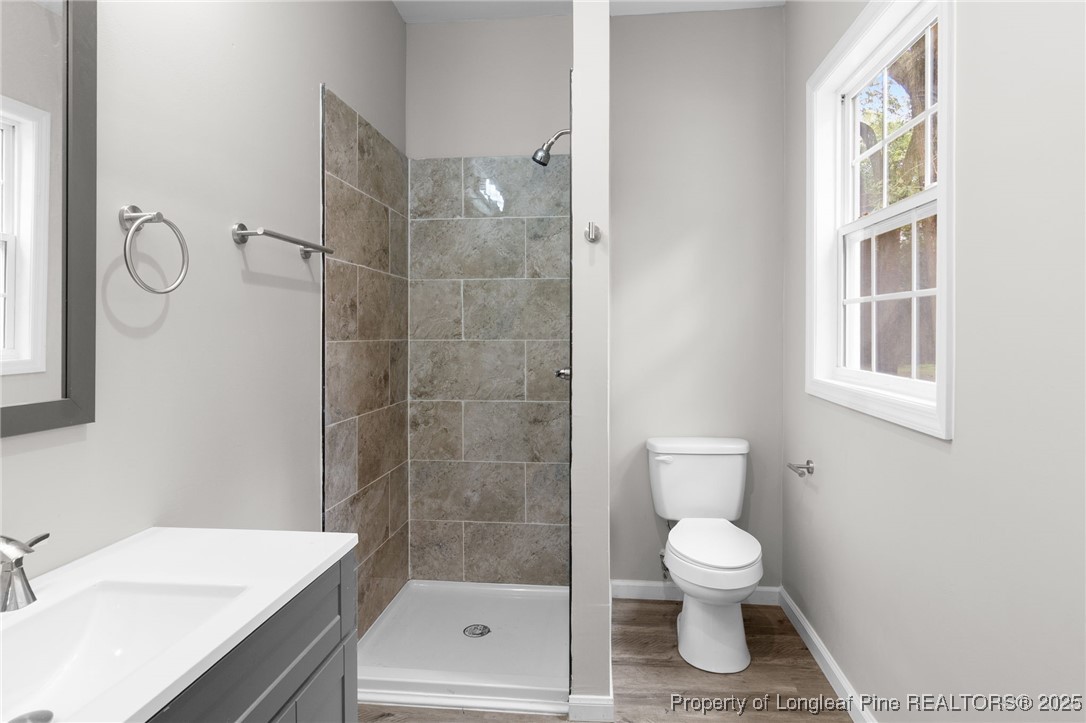 402 Morro Street Fairmont, NC 28340 - Photo 18 of 36 a bathroom with a granite countertop toilet sink and shower
