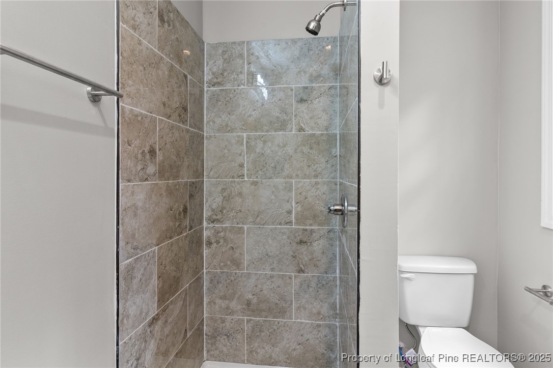 402 Morro Street Fairmont, NC 28340 - Photo 19 of 36 a bathroom with a toilet and a shower