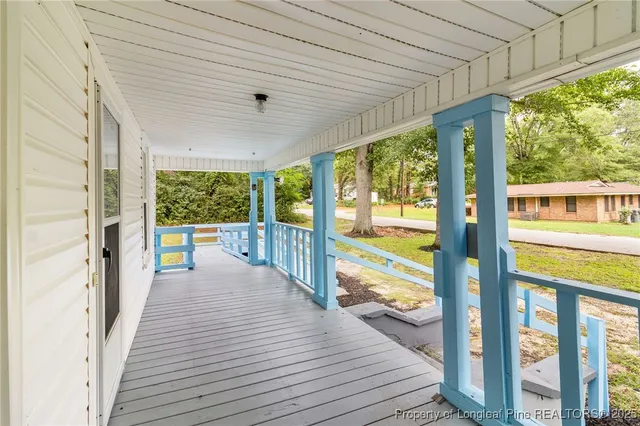 a view of a balcony with wooden floor