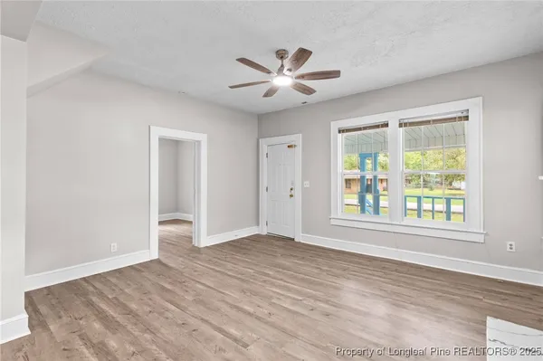 wooden floor in an empty room with a window